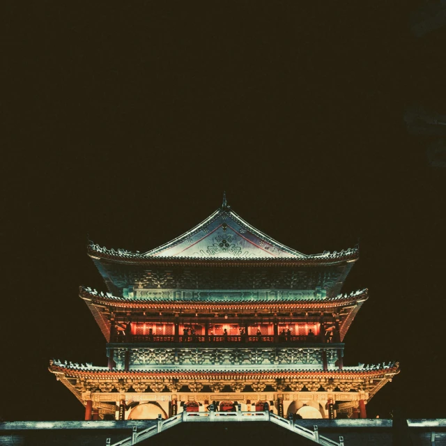 an elaborate chinese tower lit up at night