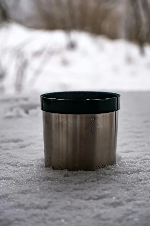 a coffee cup is sitting in the snow