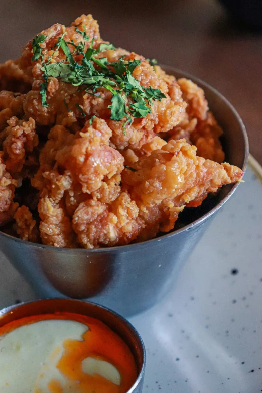 a small metal bowl of food on a table