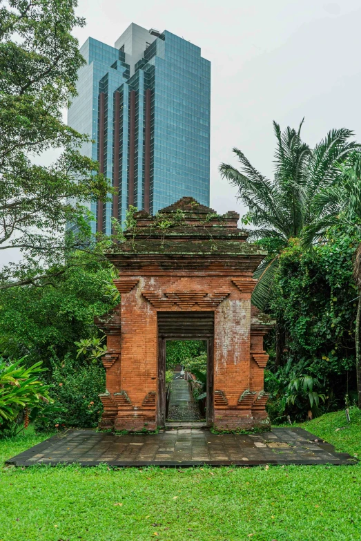 an open entrance to a park with trees on the side