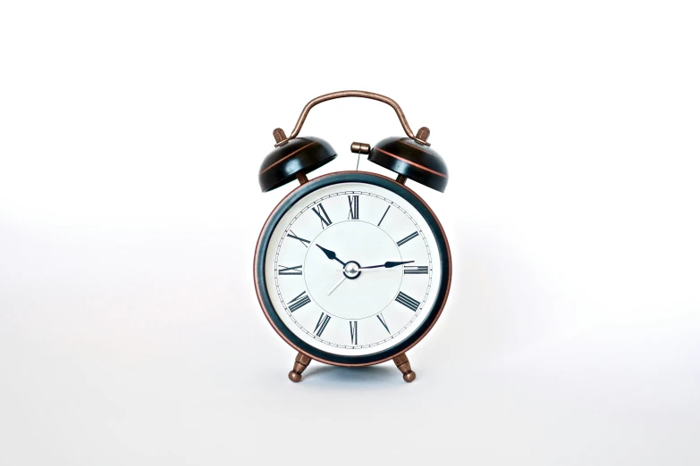 an alarm clock sitting on top of a white table