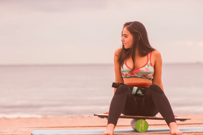 there is a female surfer sitting on the board and holding the paddle