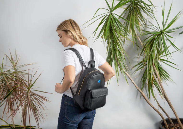 a woman holding onto the back of a bag