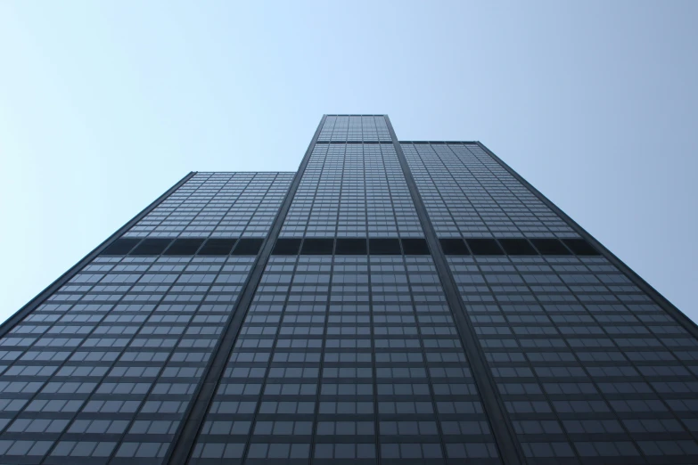 a tall building that has windows and a clock on top