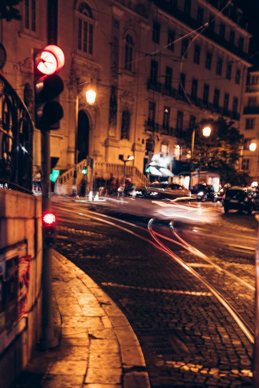 a traffic light on a brick street at night