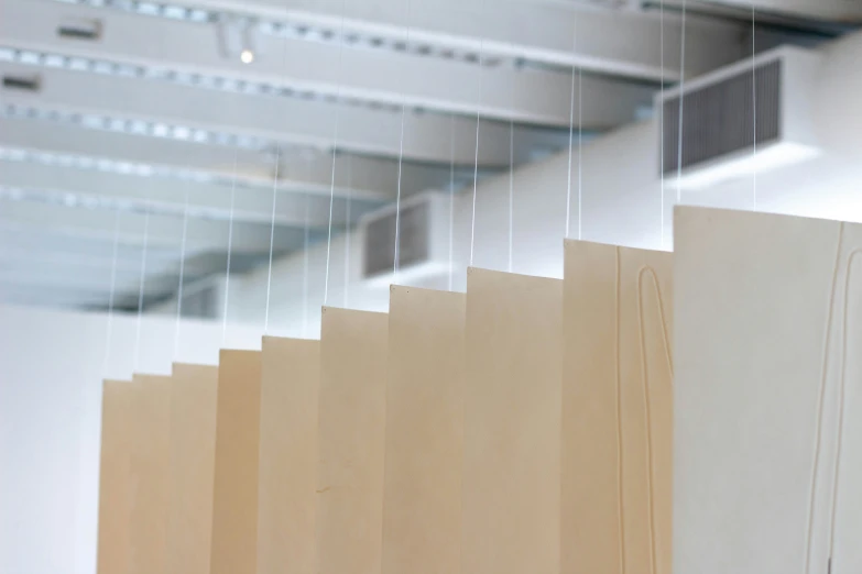 a number of unfinished wood boards hanging from a ceiling