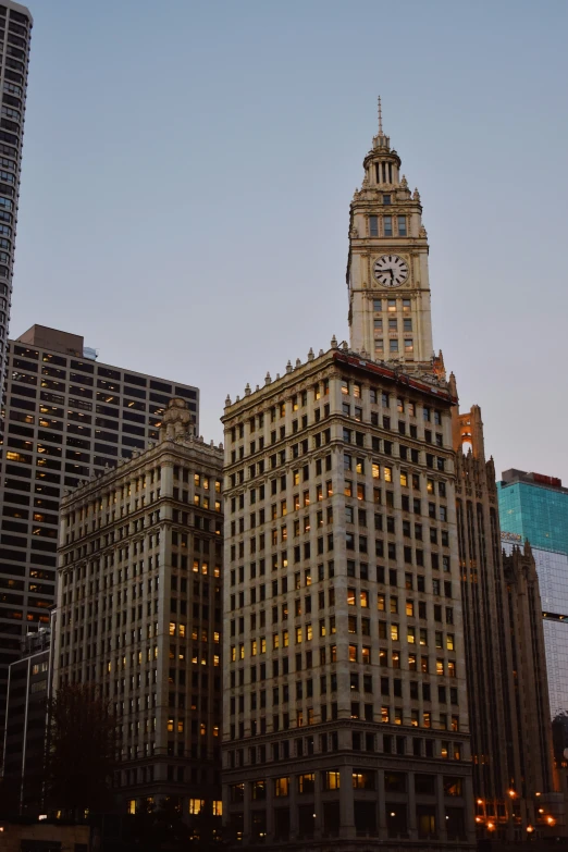 the tall buildings are illuminated at night on the side