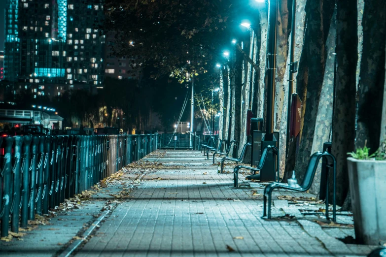 the bench is empty on the sidewalk outside