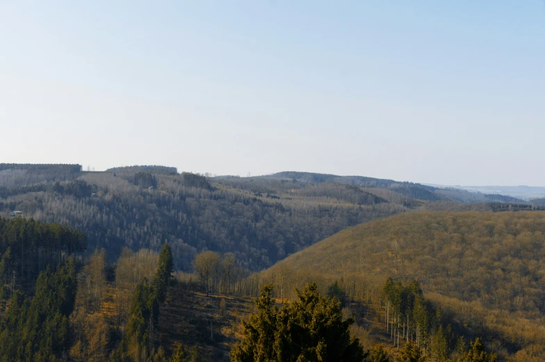 an area with mountains covered in grass and trees