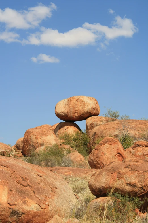 a rock formation in the middle of some big rocks