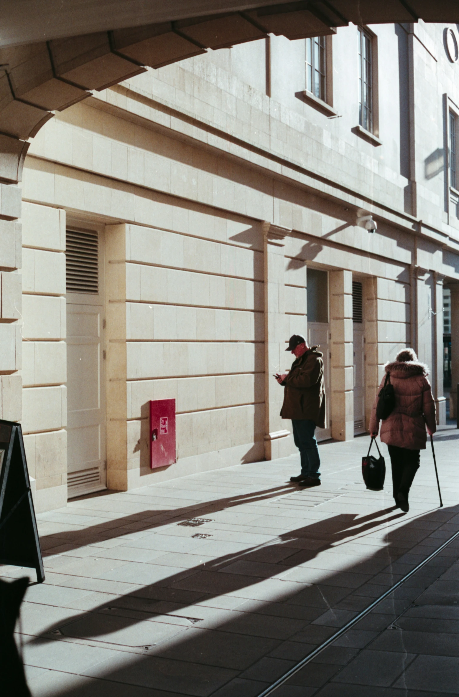 two people walking down the street in an alley