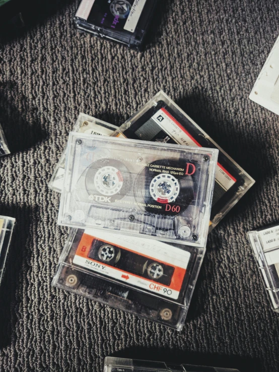 a collection of cassettes sit on the floor