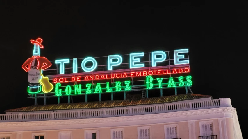 a sign is lit on top of the building