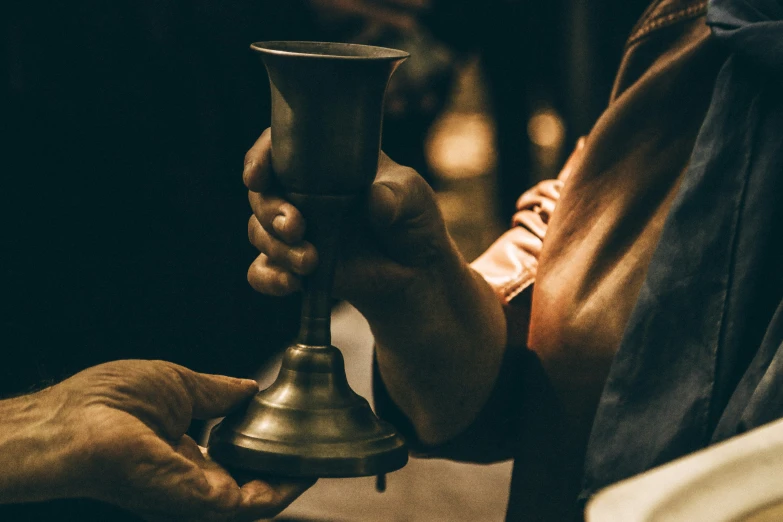 someone is holding a small bell that has been placed on top