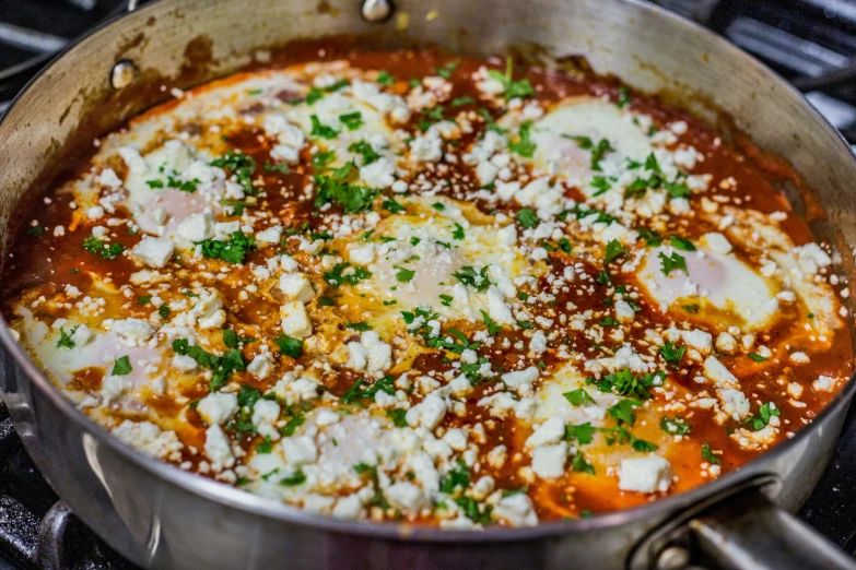 a bowl full of food that includes sauce and parmesan