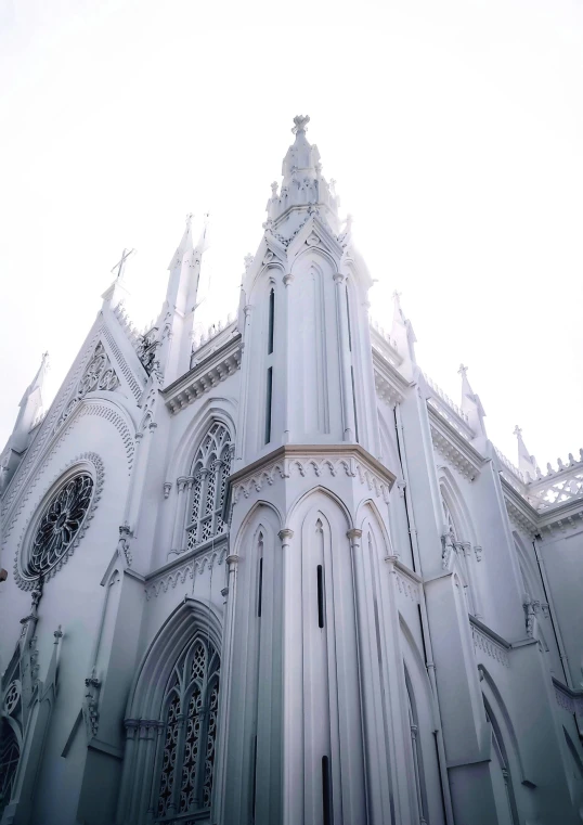 a large cathedral with many windows sitting next to the street