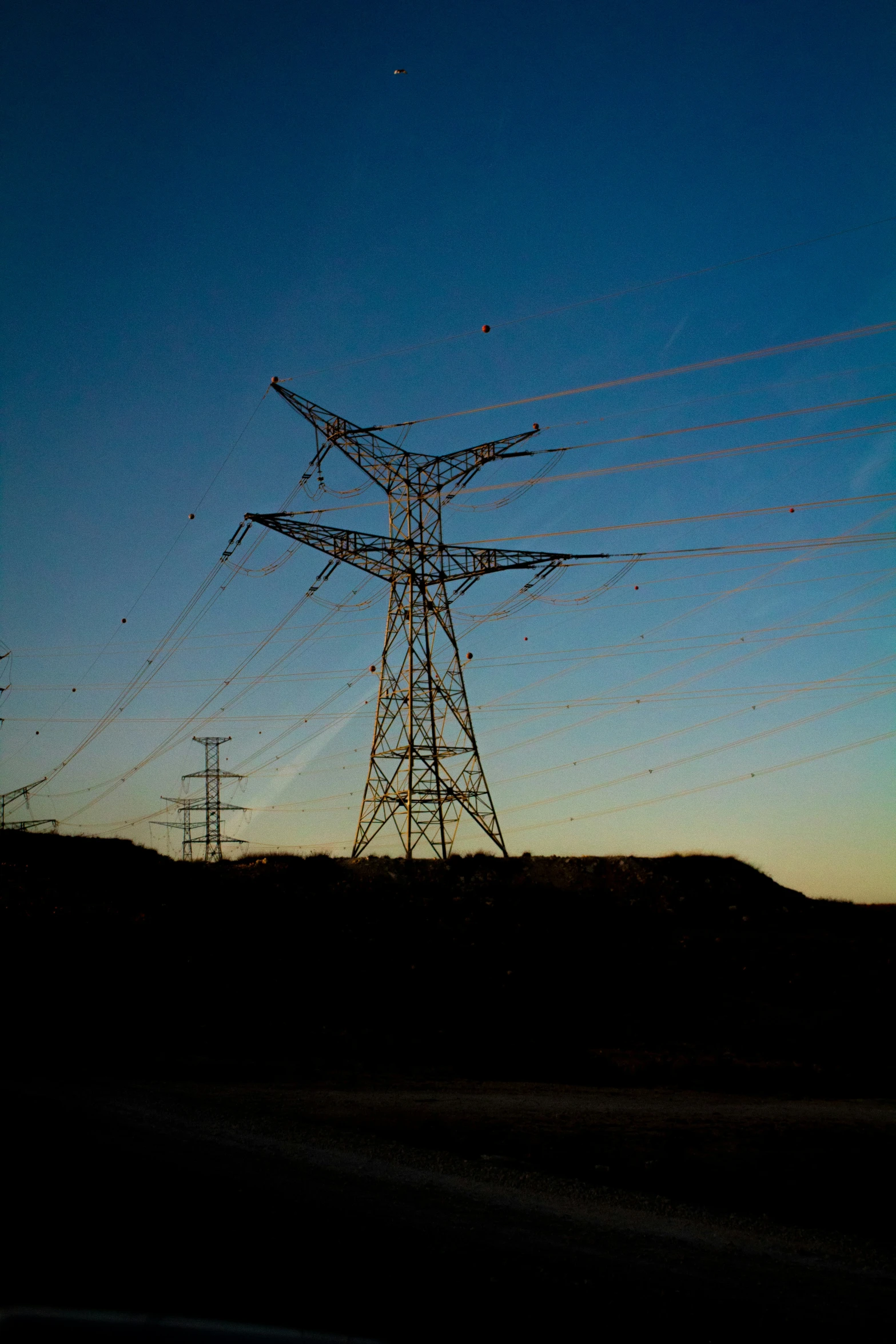 a power pole in a field during the night time