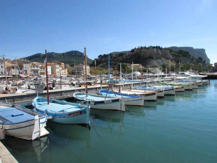 several boats docked on the water next to each other