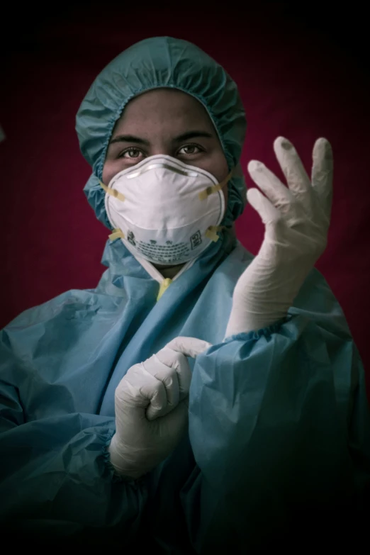 a nurse wears a medical mask and latex gloves