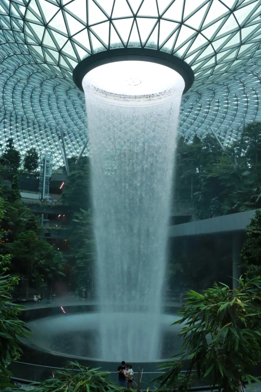 a waterfall being sprayed from the ceiling in a public area