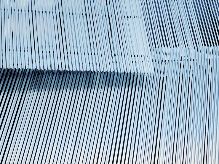 abstract image of blue vertical lines against a blue sky