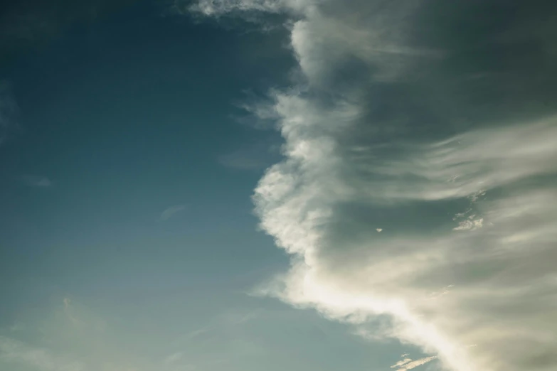 an airplane is flying in a blue sky