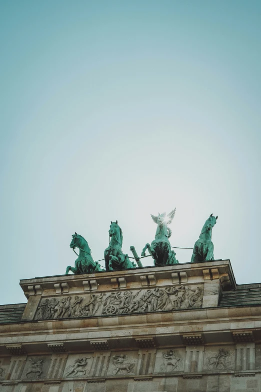 statues of angels atop a monument on a clear day