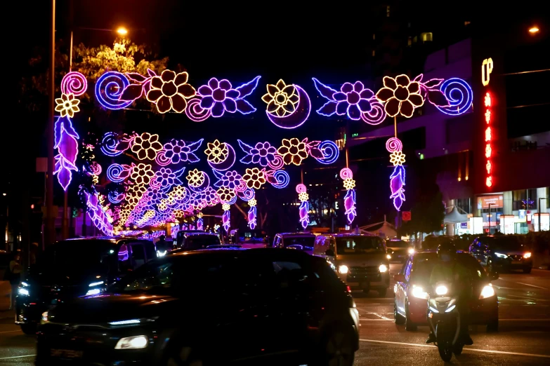 a city street lit up with colorful lights at night