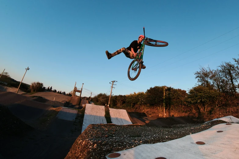 a person jumps their bike in the air