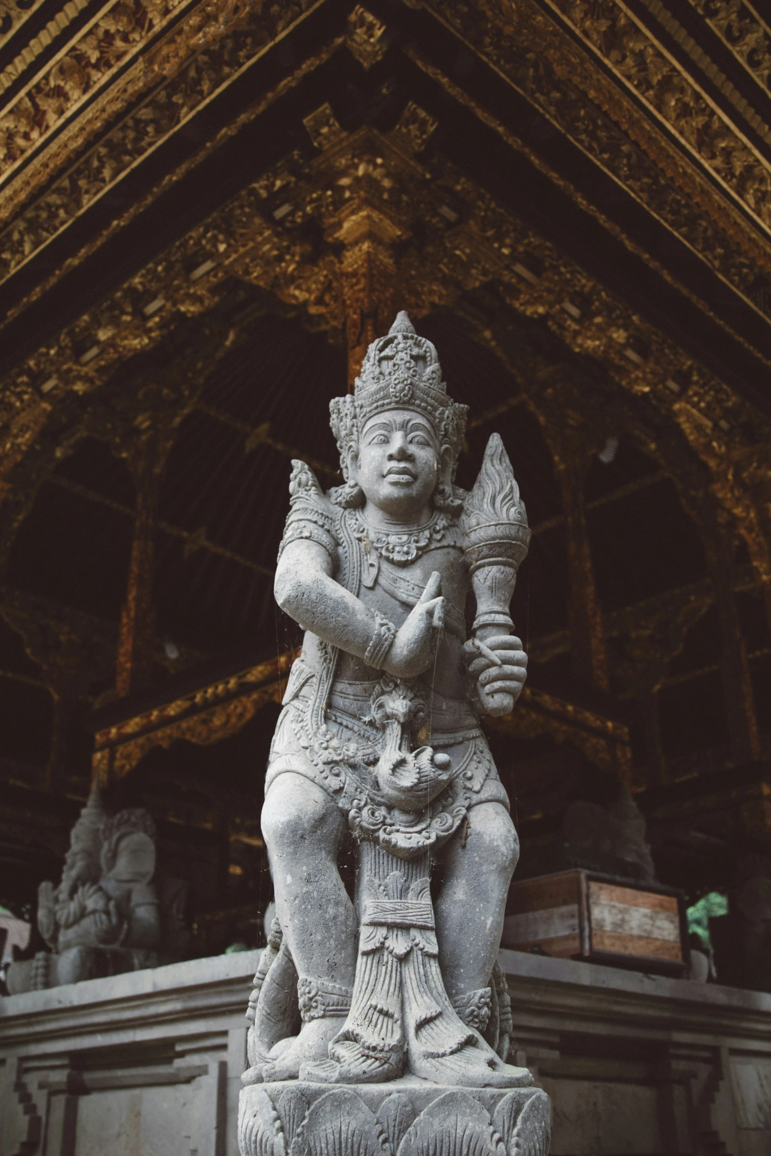 a large statue of an indian god sitting on it's pedestal