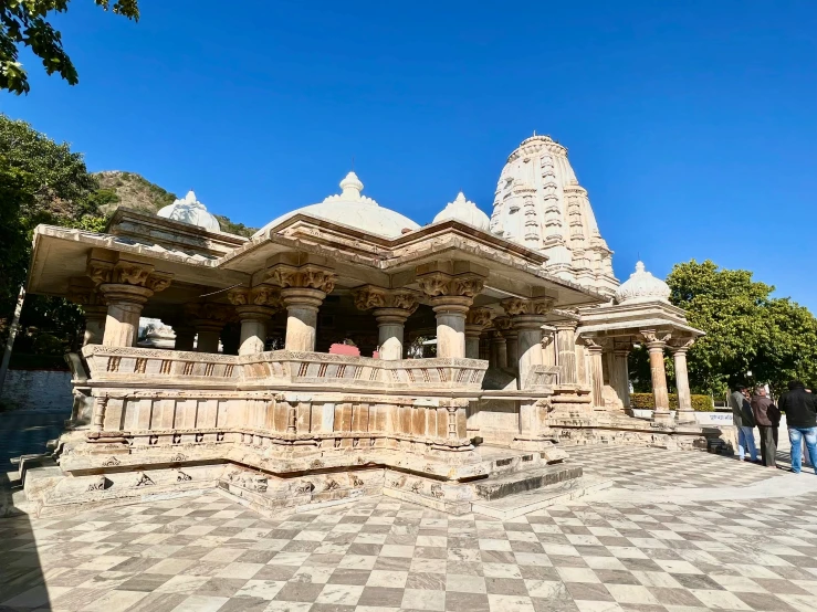 people standing on and next to stone work