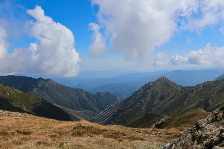 mountains in the distance with clouds above them