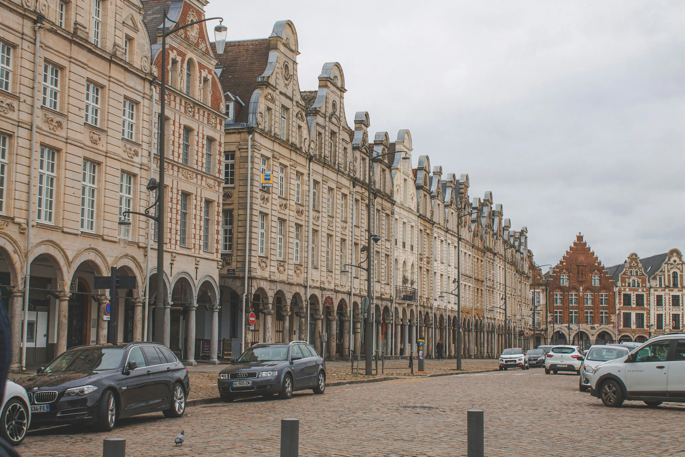 a row of buildings and cars in a city