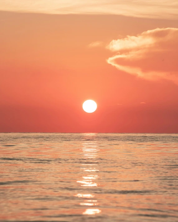 the setting sun on the horizon as seen from a sailboat