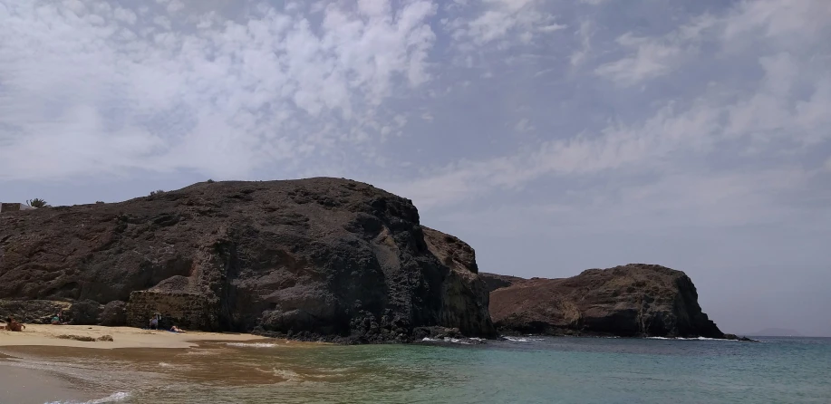 a white sand beach and a cliff that looks like an island