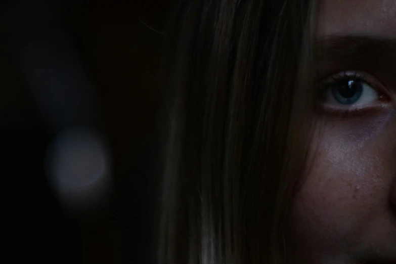 a close up view of the eyes of a female with dark hair