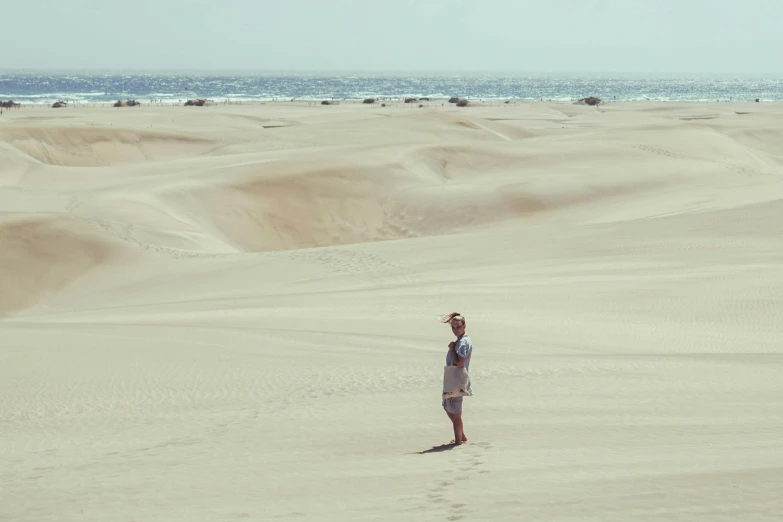 a woman is in the desert on a sunny day