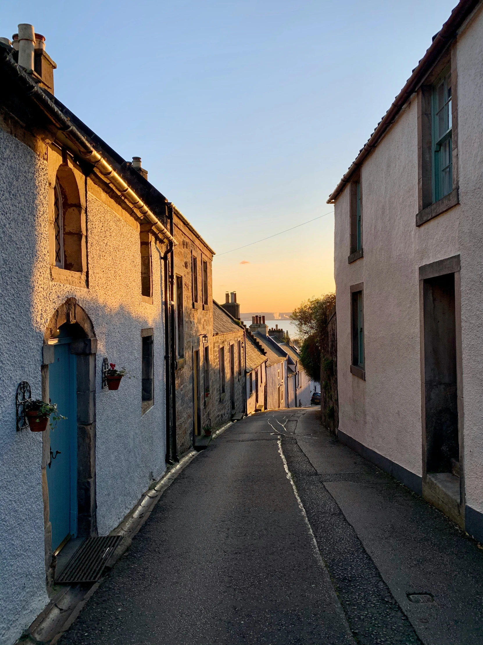 an empty street with tall houses along it