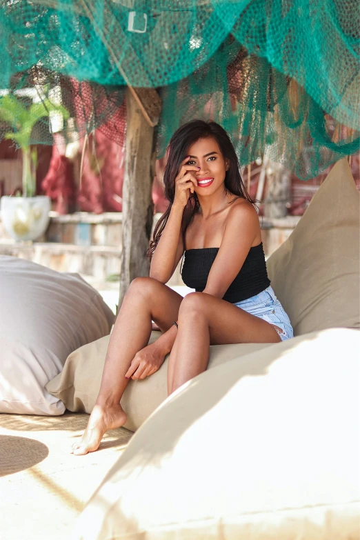 a woman sitting on a couch talking on a phone