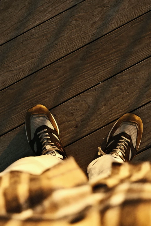 a person is looking down at their sneakers on the ground