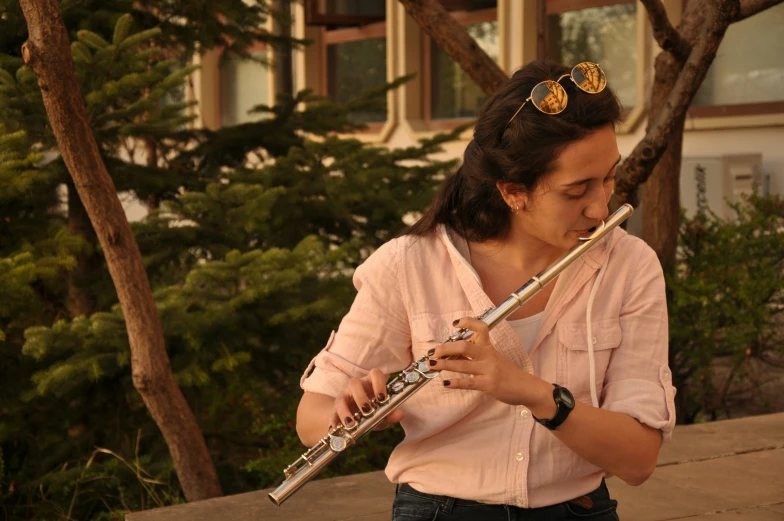 an image of woman playing flute on a balcony