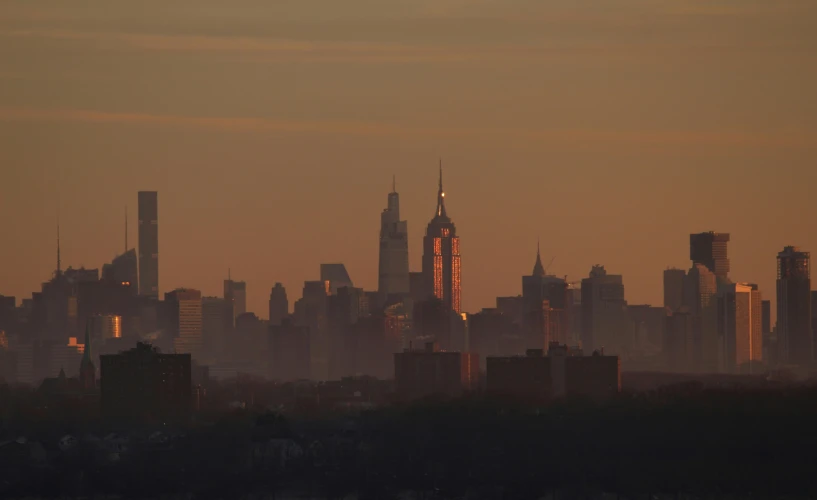 a city skyline with skyscrs at sunset