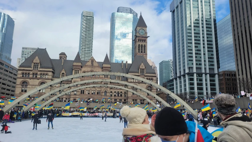 people standing on the frozen walkway looking at some buildings