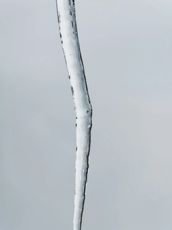 the side of a water spout sticking out of the air