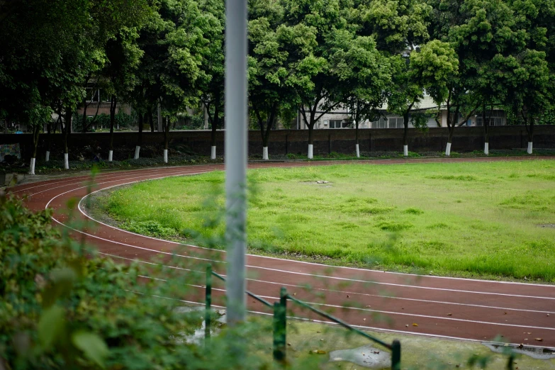 a view from above of a running track with trees in the distance