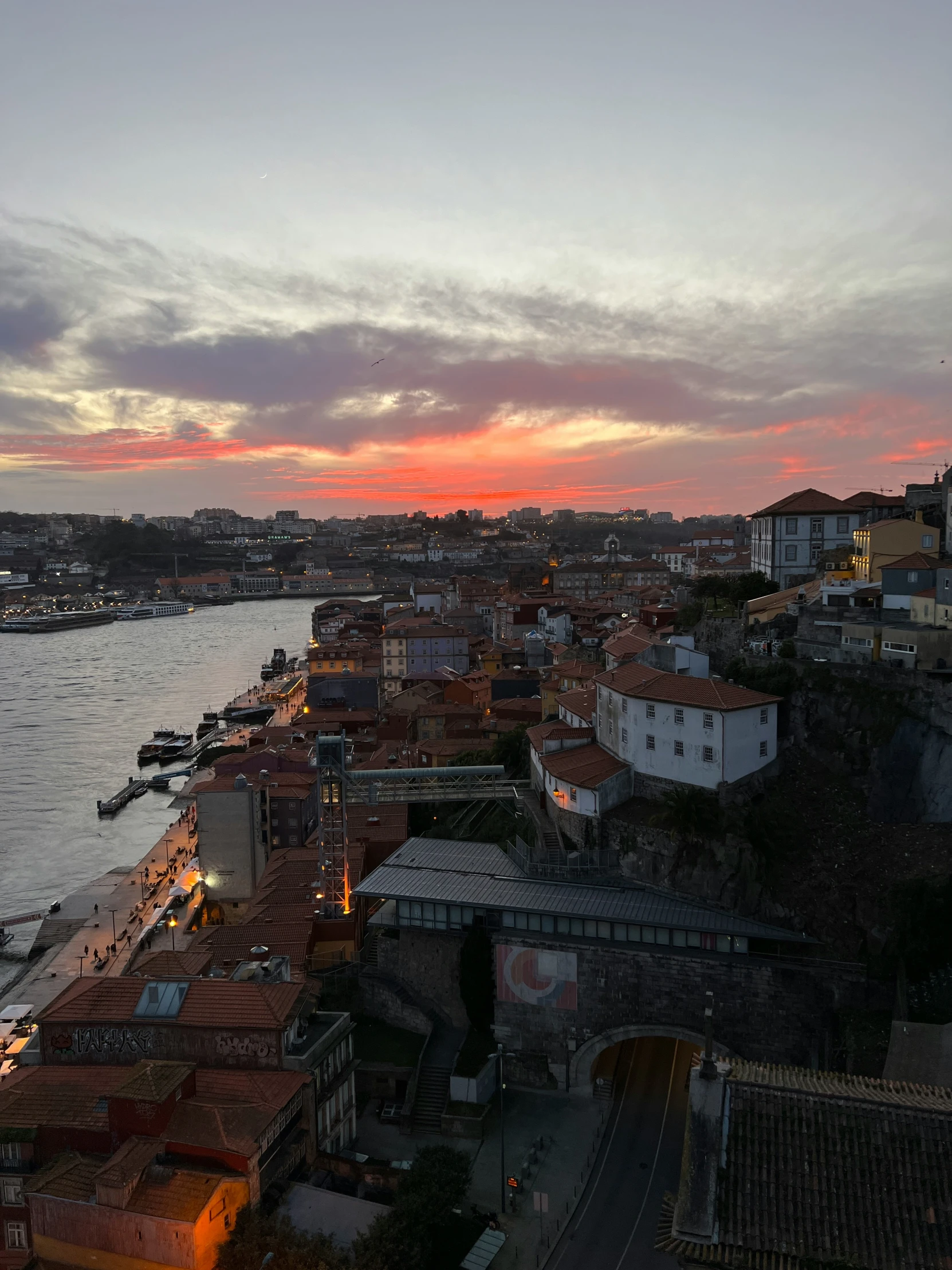 an aerial view of city from a hill in the evening