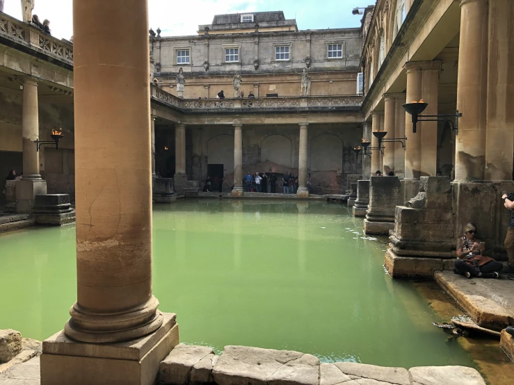 a man stands at the center of a courtyard