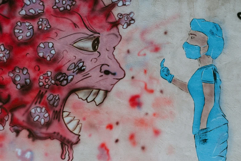 graffiti depicting a woman wearing a mask talking on the phone and a large blue monster