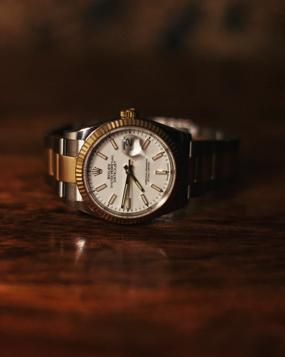 a wrist watch sitting on a table in front of a camera