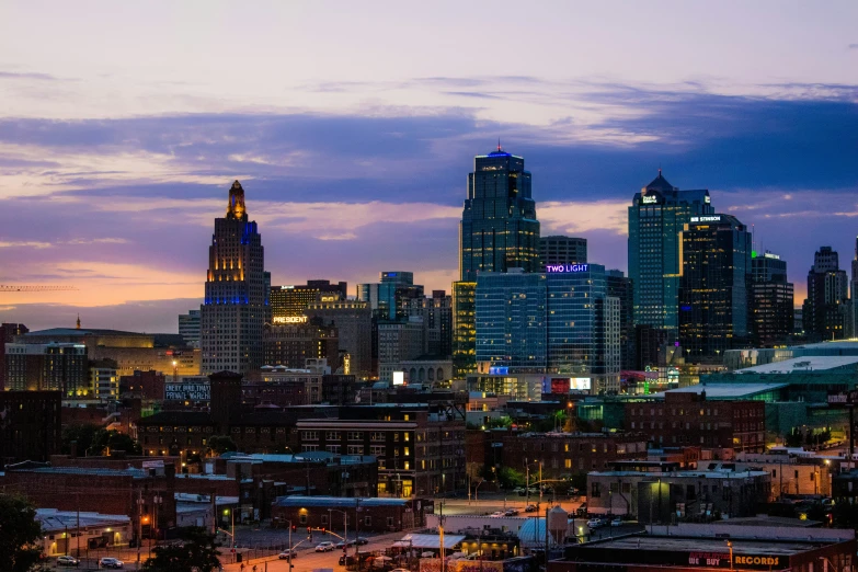 a very tall cityscape in the dark purple sky